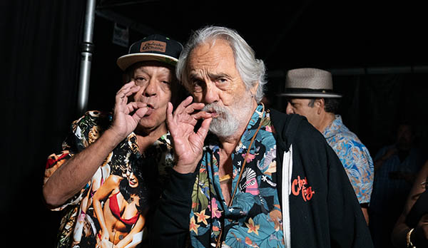 Cheech Marin and Tommy Chong posing as if they are smoking a joint